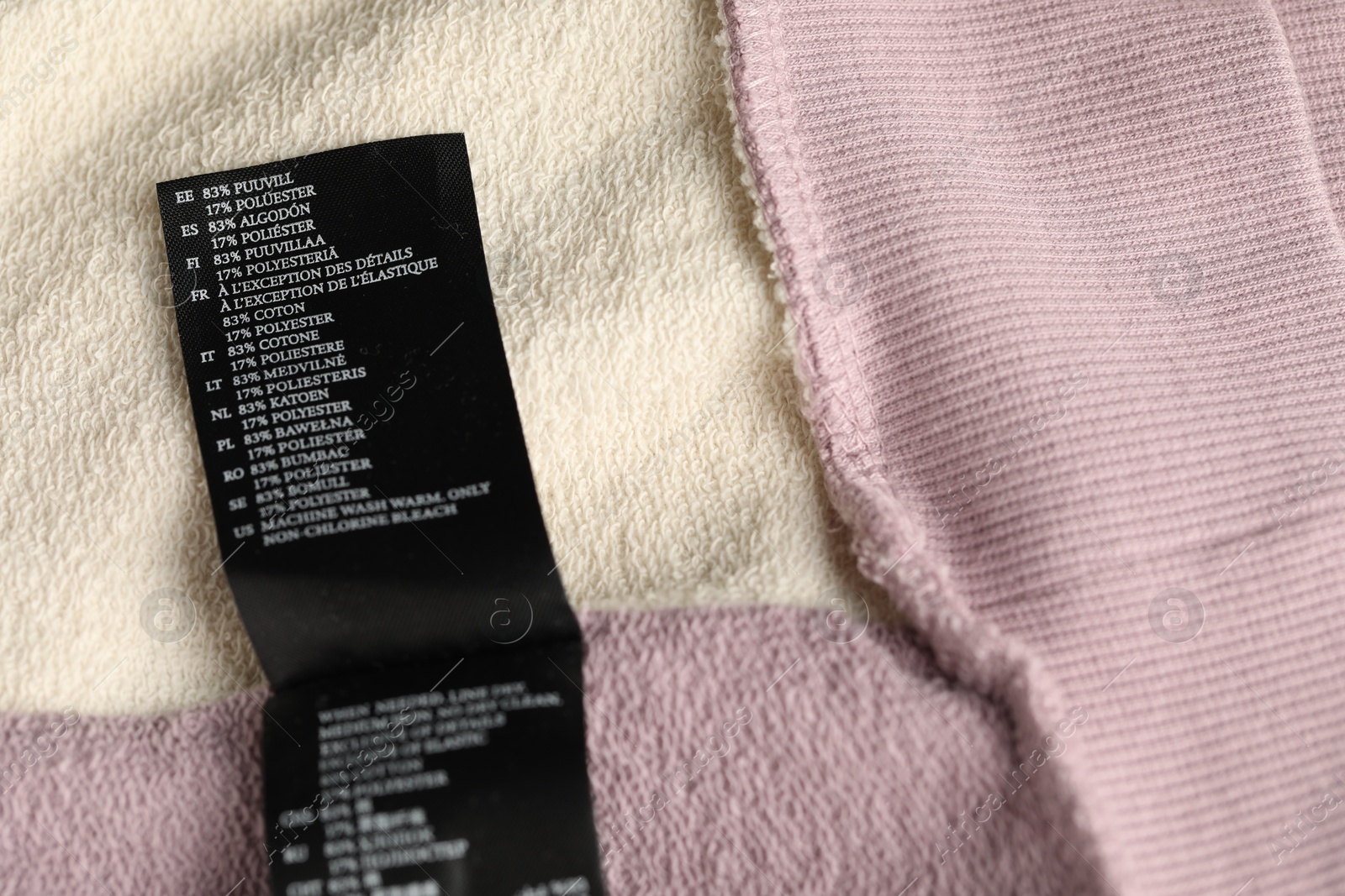 Clothing label with material content on color garment as background, above view Photo of Clothing label with material content on color garment as background, above view