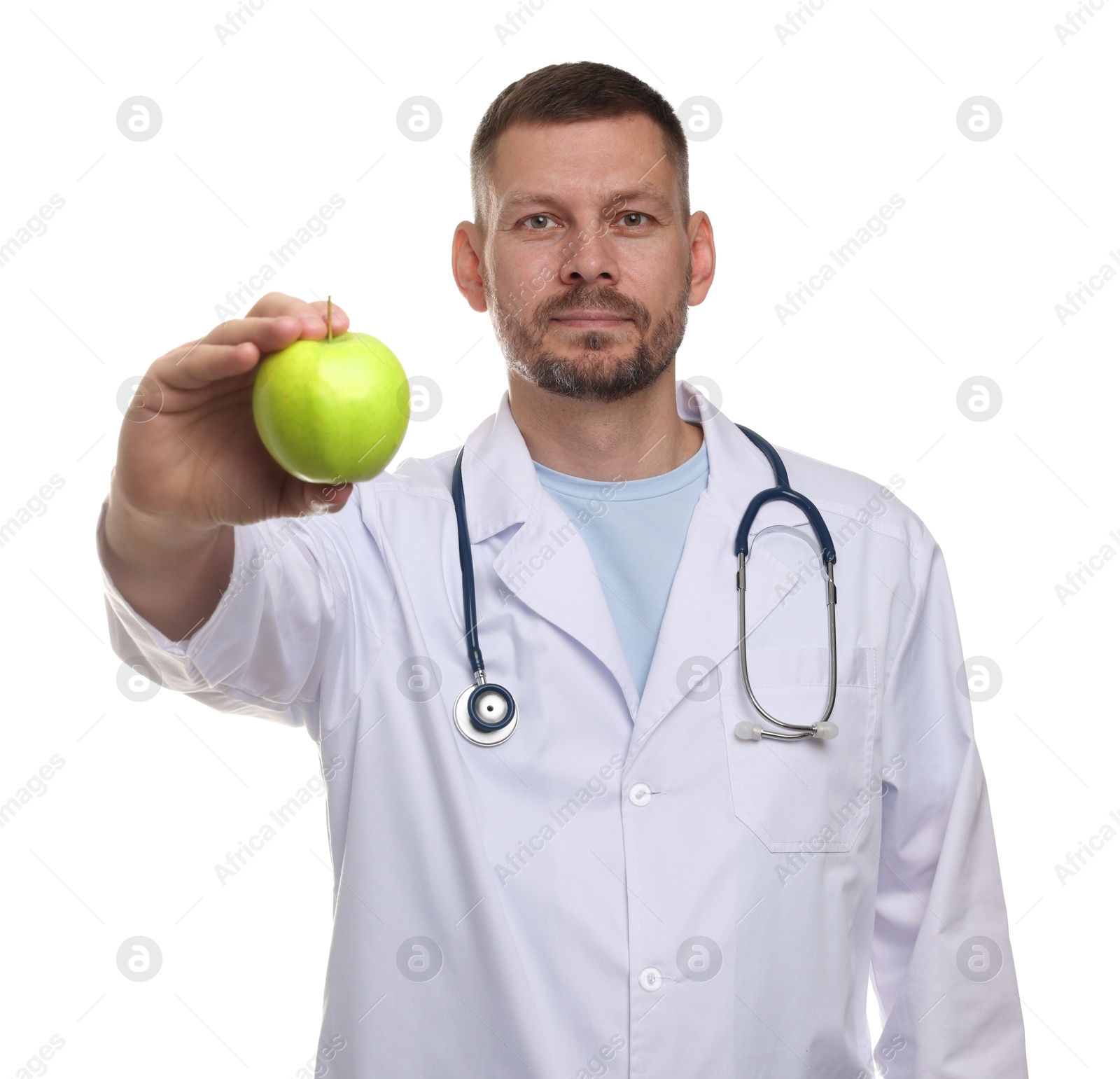 Photo of Nutritionist with green apple and stethoscope on white background