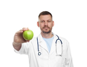 Photo of Nutritionist with green apple and stethoscope on white background