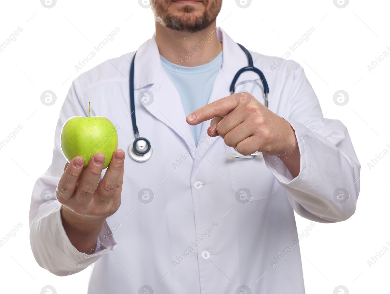 Photo of Nutritionist with green apple and stethoscope on white background, closeup