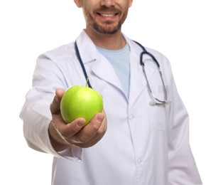 Photo of Nutritionist with green apple and stethoscope on white background, closeup