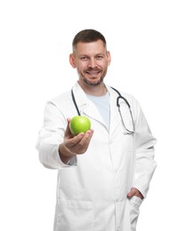 Photo of Nutritionist with green apple and stethoscope on white background