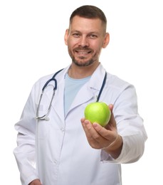 Photo of Nutritionist with green apple and stethoscope on white background