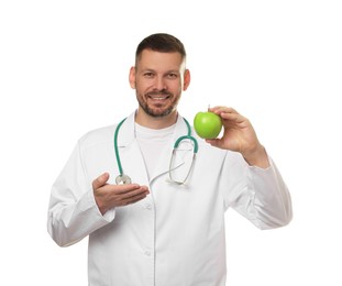 Photo of Nutritionist with green apple and stethoscope on white background