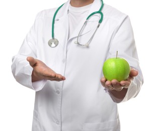 Photo of Nutritionist with green apple and stethoscope on white background, closeup