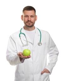 Photo of Nutritionist with green apple and stethoscope on white background