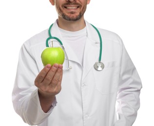 Photo of Nutritionist with green apple and stethoscope on white background, closeup