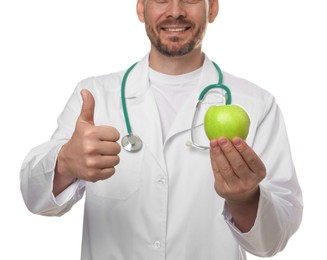 Photo of Nutritionist with green apple and stethoscope showing thumbs up on white background, closeup