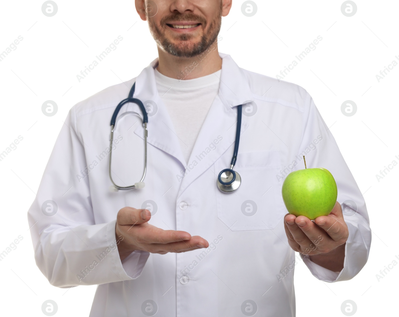 Photo of Nutritionist with green apple and stethoscope on white background, closeup