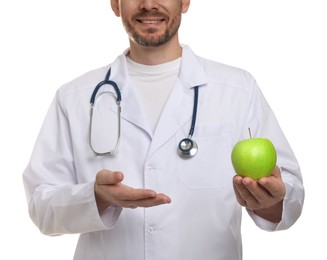 Photo of Nutritionist with green apple and stethoscope on white background, closeup