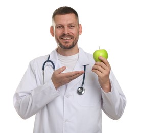 Photo of Nutritionist with green apple and stethoscope on white background