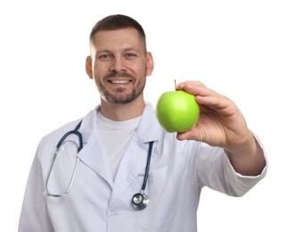 Photo of Nutritionist with green apple and stethoscope on white background, selective focus