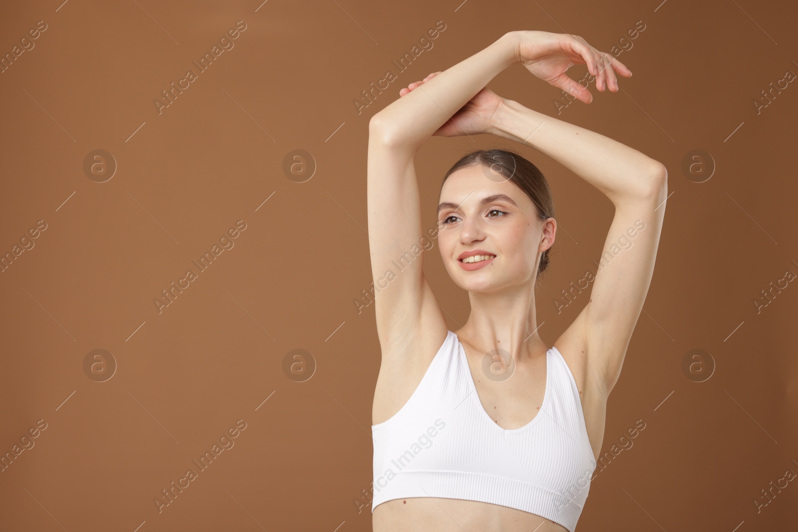 Portrait of beautiful young woman on beige background. Space for text Photo of Portrait of beautiful young woman on beige background. Space for text