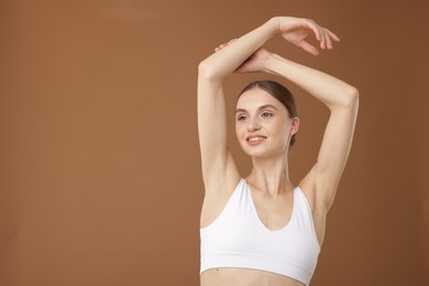 Photo of Portrait of beautiful young woman on beige background. Space for text