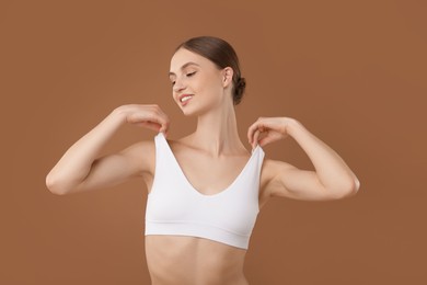 Photo of Portrait of beautiful young woman on beige background