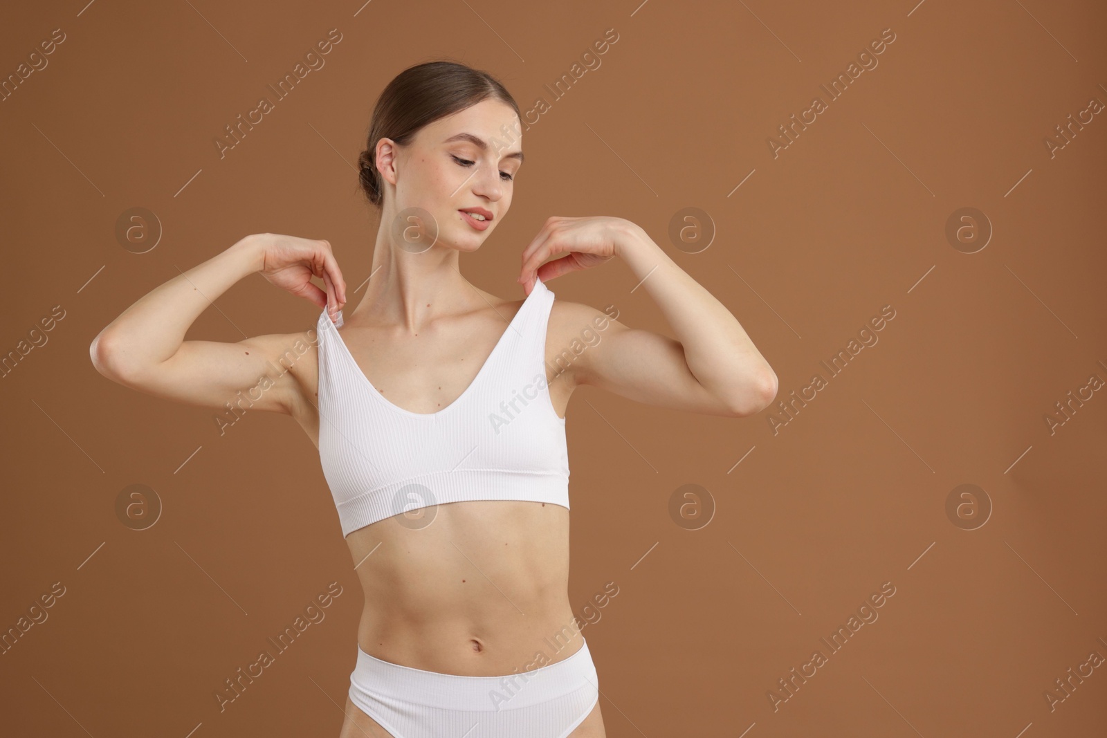 Beautiful woman with perfect slim body on beige background Photo of Beautiful woman with perfect slim body on beige background