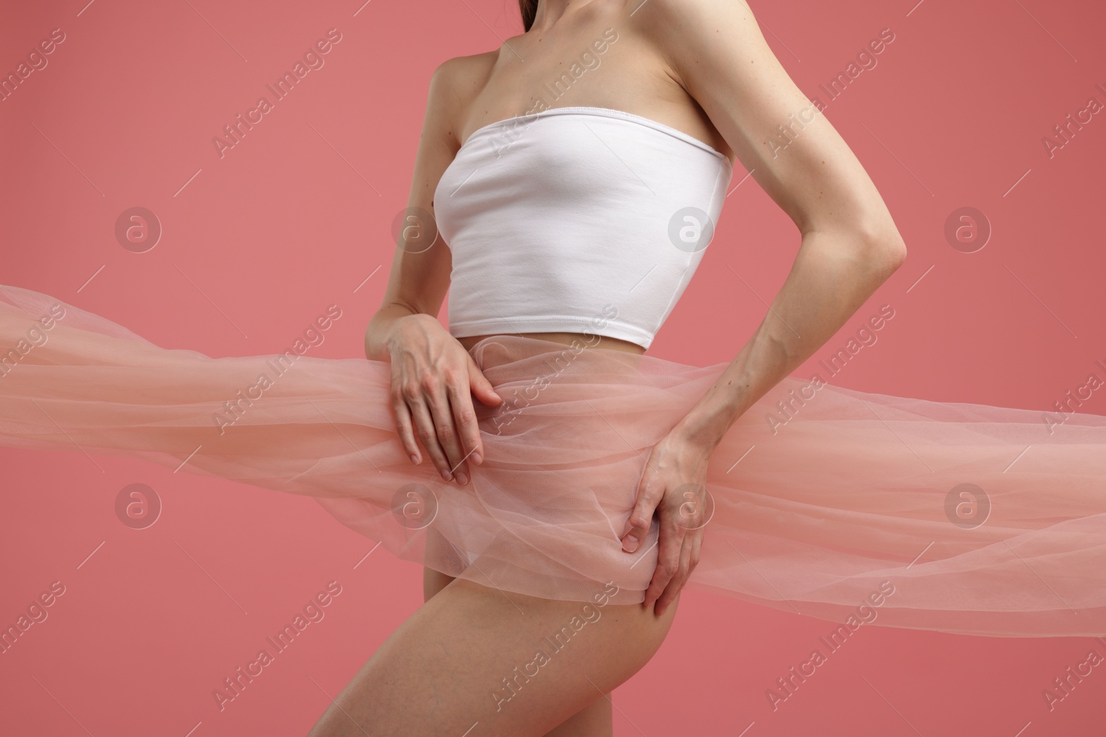 Photo of Young woman with beautiful fabric on pink background, closeup