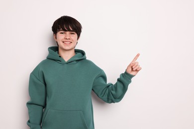 Photo of Portrait of teenage boy on white background, space for text