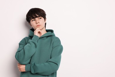 Photo of Portrait of teenage boy on white background, space for text
