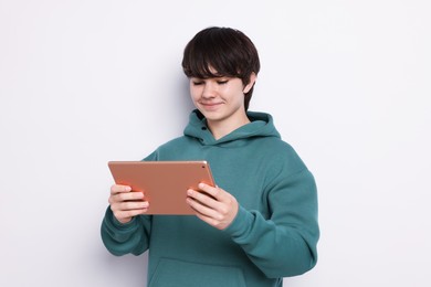 Photo of Teenage boy with tablet on white background