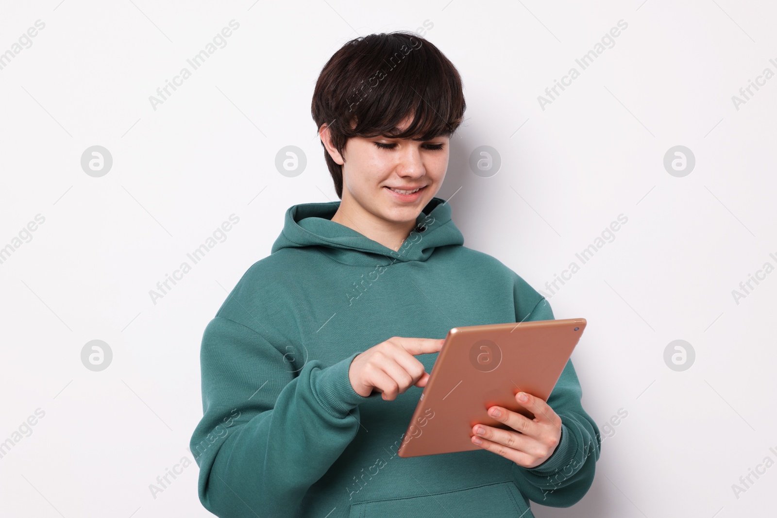 Teenage boy with tablet on white background Photo of Teenage boy with tablet on white background