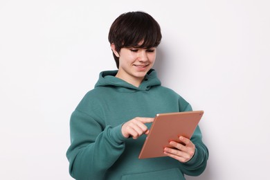 Photo of Teenage boy with tablet on white background