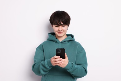 Photo of Teenage boy with smartphone on white background