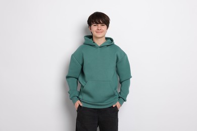 Photo of Portrait of teenage boy on white background
