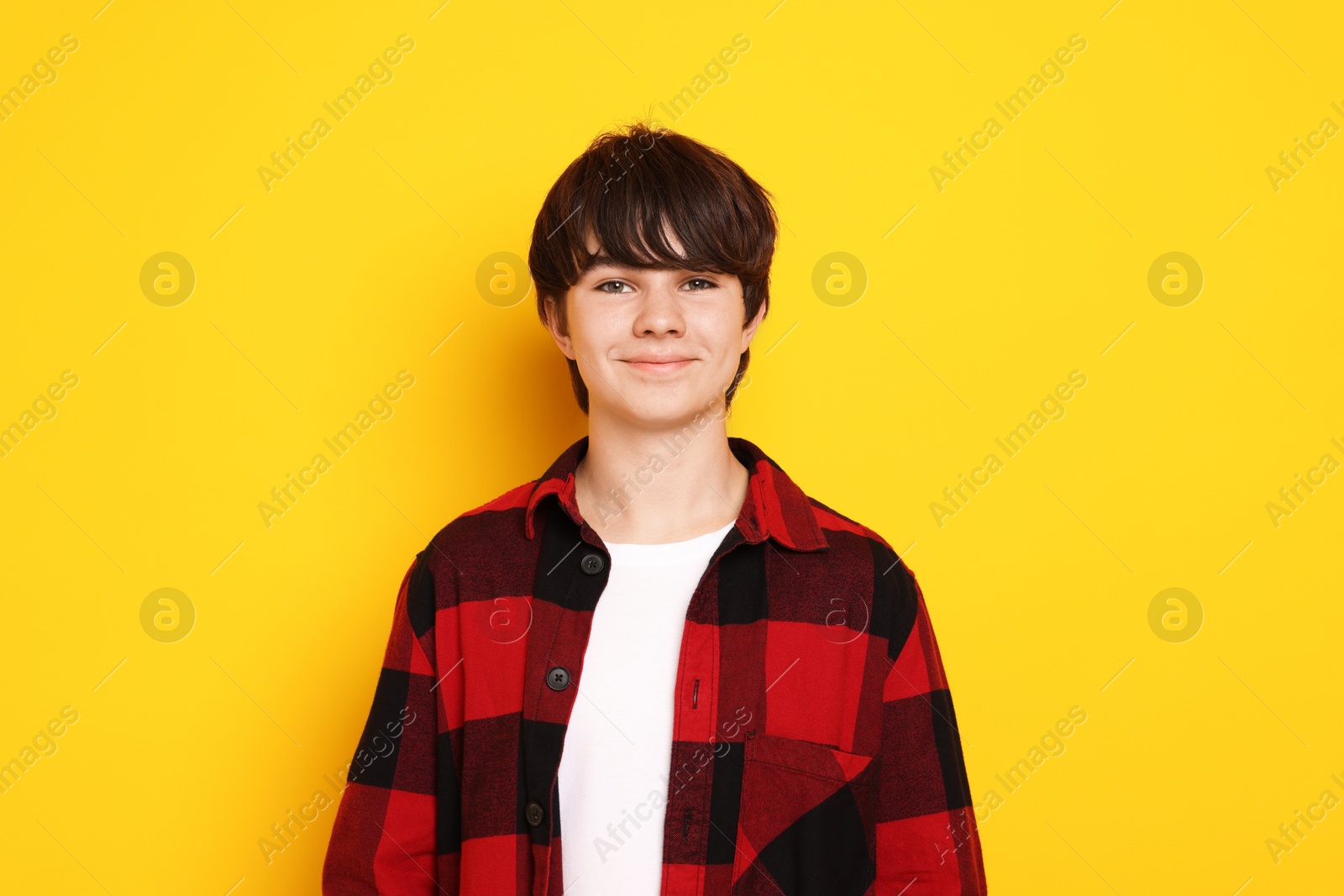 Photo of Portrait of teenage boy on orange background