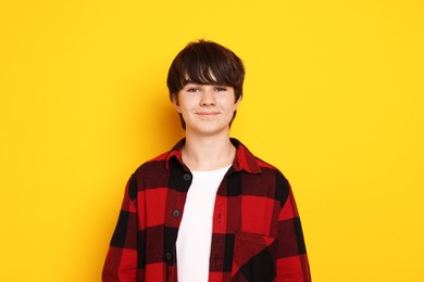 Photo of Portrait of teenage boy on orange background
