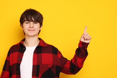 Photo of Portrait of teenage boy on orange background