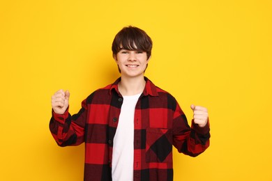 Photo of Portrait of teenage boy on orange background