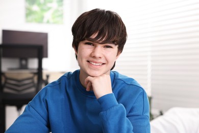 Photo of Portrait of happy teenage boy at home