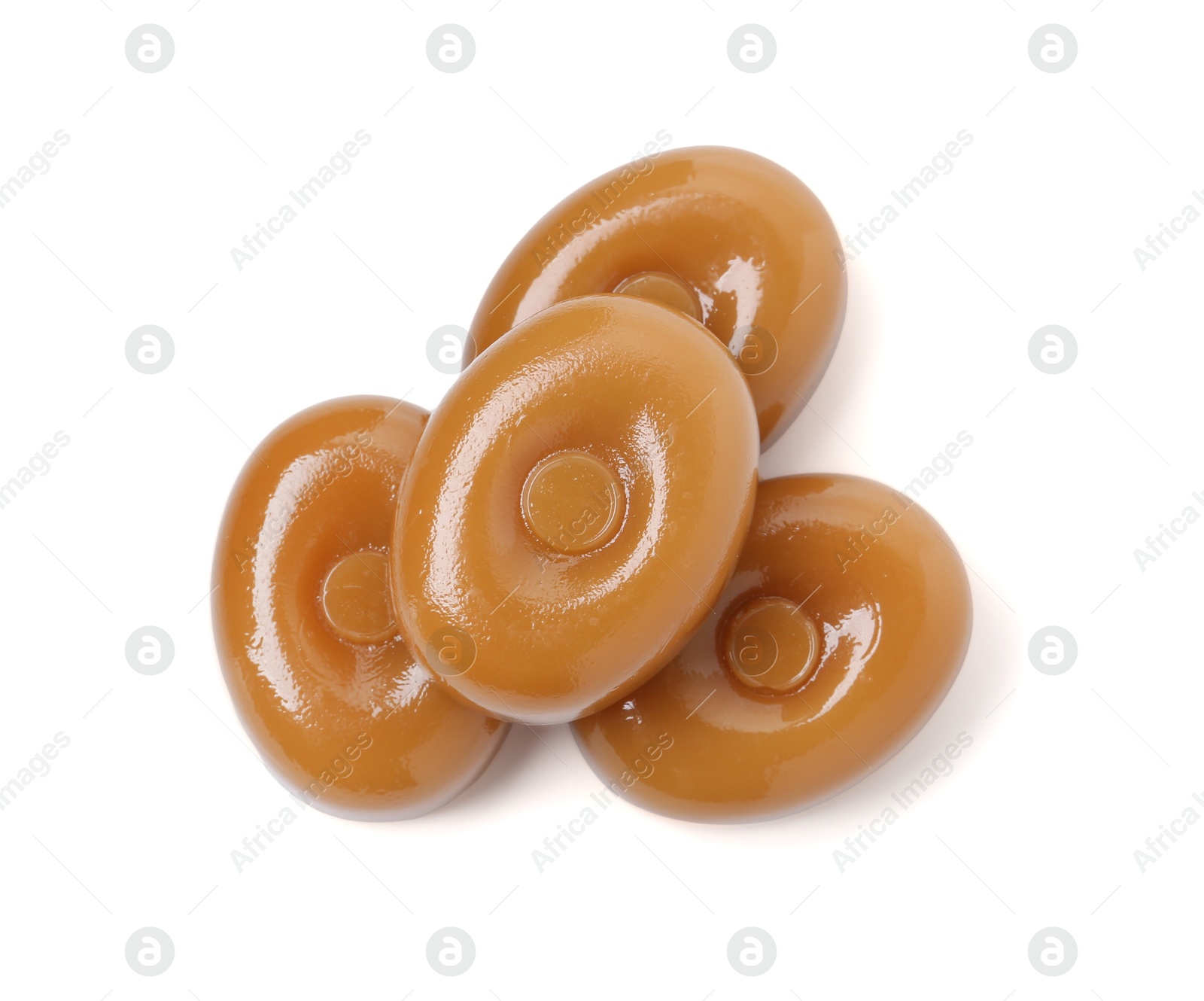 Tasty hard toffee candies isolated on white, top view Photo of Tasty hard toffee candies isolated on white, top view