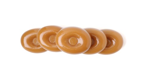 Photo of Tasty hard toffee candies isolated on white, top view