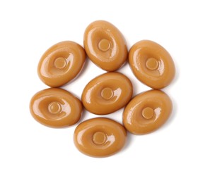Photo of Tasty hard toffee candies isolated on white, top view