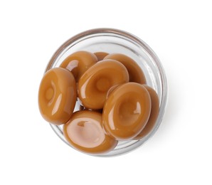Photo of Tasty sweet caramel candies isolated on white, top view
