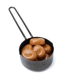 Photo of Tasty sweet caramel candies isolated on white
