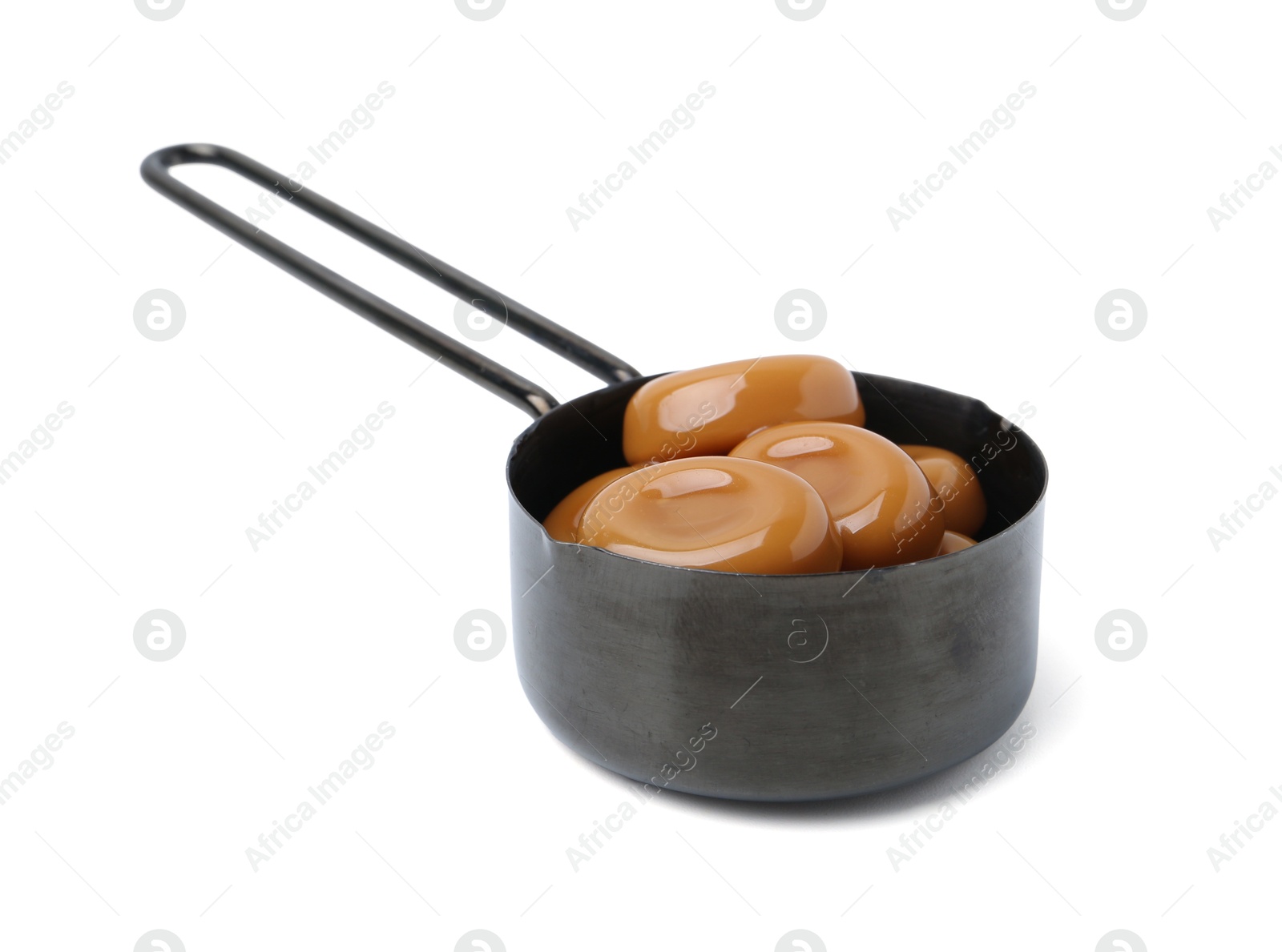 Tasty sweet caramel candies isolated on white Photo of Tasty sweet caramel candies isolated on white