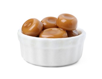 Photo of Tasty sweet caramel candies isolated on white
