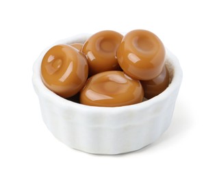 Photo of Tasty sweet caramel candies isolated on white