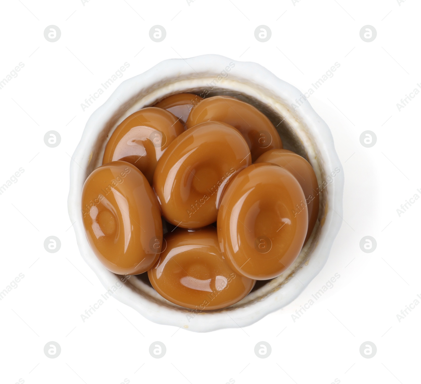 Tasty sweet caramel candies isolated on white, top view Photo of Tasty sweet caramel candies isolated on white, top view