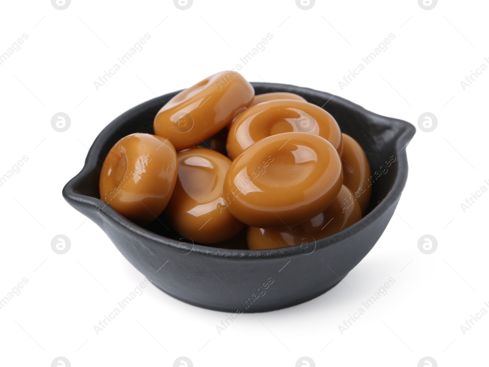 Tasty sweet caramel candies isolated on white Photo of Tasty sweet caramel candies isolated on white