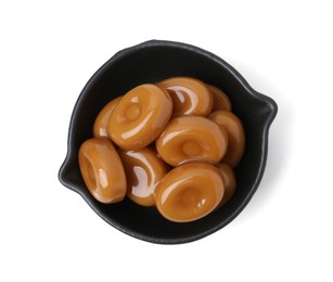 Photo of Tasty sweet caramel candies isolated on white, top view