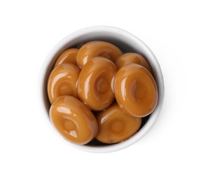 Photo of Tasty sweet caramel candies isolated on white, top view