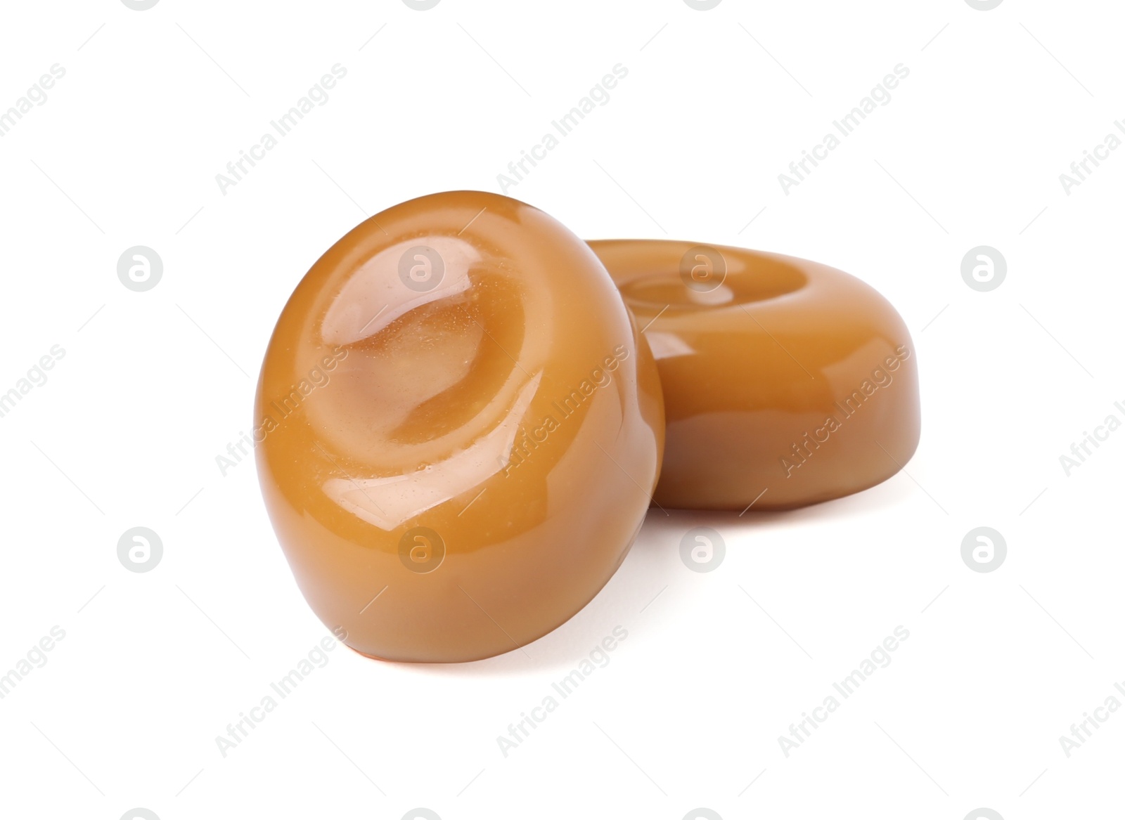 Tasty sweet caramel candies isolated on white Photo of Tasty sweet caramel candies isolated on white