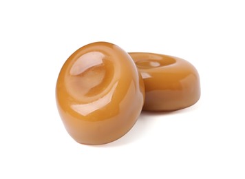 Photo of Tasty sweet caramel candies isolated on white