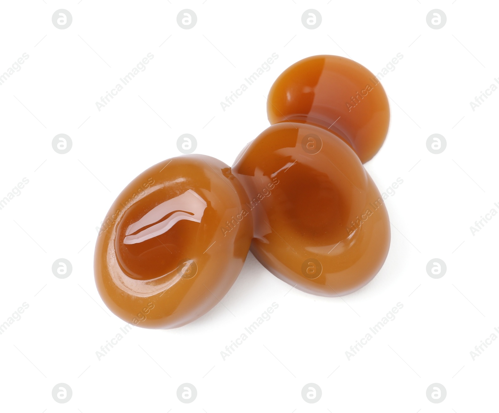 Tasty sweet candies and caramel sauce isolated on white, top view Photo of Tasty sweet candies and caramel sauce isolated on white, top view
