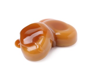 Photo of Tasty sweet candies and caramel sauce isolated on white