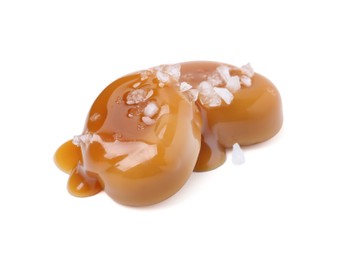 Photo of Tasty sweet candies, salt and caramel sauce isolated on white